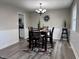 Dining room with chandelier, room for 4, and view into the kitchen at 383 Carmelaire Ct, Carmel, IN 46032