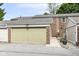 Spacious garage with brick accents and well-maintained landscaping offering ample parking and curb appeal to the property at 383 Carmelaire Ct, Carmel, IN 46032