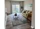 Comfortable living room with sliding glass doors to the backyard and stylish rug at 383 Carmelaire Ct, Carmel, IN 46032