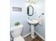 Clean powder room with pedestal sink and decorative accents at 383 Carmelaire Ct, Carmel, IN 46032