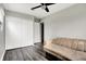 Bright bedroom with a large closet, gray walls, modern ceiling fan, and vinyl flooring, offering style and comfort at 8902 Carla Dr, Indianapolis, IN 46219