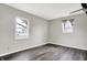 A bedroom featuring two large windows, neutral paint, and dark wood-look floors at 8902 Carla Dr, Indianapolis, IN 46219