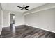Expansive bonus room featuring vinyl floors, neutral walls, and ceiling fan, ready for customization and relaxation at 8902 Carla Dr, Indianapolis, IN 46219
