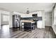 Open kitchen featuring white cabinets, stainless steel appliances and dark wood-look floors at 8902 Carla Dr, Indianapolis, IN 46219