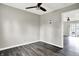 A well lit living room with dark wood-look floors and access to other rooms at 8902 Carla Dr, Indianapolis, IN 46219