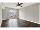 Bright living room with dark wood-look floors and sliding glass door to backyard at 8902 Carla Dr, Indianapolis, IN 46219