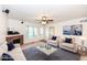 A spacious living room with neutral colored furniture, a fireplace, and a ceiling fan at 11736 Grazing Ln, Indianapolis, IN 46239