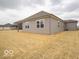 Backyard of home with newly installed grass and neutral colored siding on home at 6322 Granby Dr, Whitestown, IN 46075