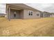 Newly built home featuring a covered patio and gray vinyl siding in the backyard with a large lawn and natural light at 6322 Granby Dr, Whitestown, IN 46075