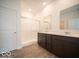 Bathroom with double vanity, dark cabinets, large mirror and a glass enclosed shower at 6322 Granby Dr, Whitestown, IN 46075