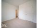 Bright bedroom featuring neutral carpet, white walls and a doorway, creating a blank canvas for personalization at 6322 Granby Dr, Whitestown, IN 46075