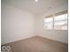 Bright bedroom with neutral carpet, a large window, and white walls, offering a cozy and serene atmosphere at 6322 Granby Dr, Whitestown, IN 46075