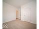 Neutral carpeted bedroom features a double door closet and a view into the adjacent room at 6322 Granby Dr, Whitestown, IN 46075