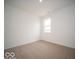 Well-lit bedroom showcasing neutral carpet, white walls and a bright window enhancing a sense of serenity at 6322 Granby Dr, Whitestown, IN 46075