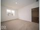 Carpeted bedroom featuring bright natural light from the window, and a door leading to the hallway at 6322 Granby Dr, Whitestown, IN 46075