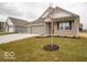 Well-maintained one-story home showcasing a three-car garage, neat landscaping, and classic architectural style at 6322 Granby Dr, Whitestown, IN 46075