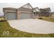 Attractive ranch-style home with a spacious driveway and three-car garage, nestled in a serene neighborhood at 6322 Granby Dr, Whitestown, IN 46075