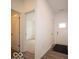 Bright hallway with wood-look flooring, white walls, and entryways leading to other rooms at 6322 Granby Dr, Whitestown, IN 46075