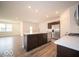 Bright, modern kitchen with stainless appliances, quartz countertops, and dark wood cabinets at 6322 Granby Dr, Whitestown, IN 46075