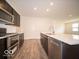 Modern kitchen features stainless steel appliances, dark cabinetry and spacious island with quartz countertops at 6322 Granby Dr, Whitestown, IN 46075