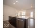 Kitchen island features stainless steel dishwasher, dark cabinetry and a large white countertop at 6322 Granby Dr, Whitestown, IN 46075