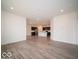 Open living space features wood-look floors, recessed lighting and access to the modern kitchen at 6322 Granby Dr, Whitestown, IN 46075