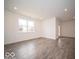 Spacious living room features wood-look floors, recessed lighting, and abundant natural light at 6322 Granby Dr, Whitestown, IN 46075
