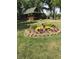 Beautiful front yard features a circular flower garden, mature trees, and a charming home at 1155 Cope Rd, Martinsville, IN 46151