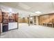 Finished basement with bar, fireplace, wood paneling, and neutral carpet at 5527 Vin Rose Ln, Lawrence, IN 46226