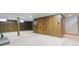 Finished basement with wood paneling and neutral carpet at 5527 Vin Rose Ln, Lawrence, IN 46226