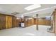 Finished basement with bar area, wood paneling, and neutral carpet at 5527 Vin Rose Ln, Lawrence, IN 46226