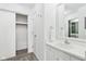 Well-lit bathroom with a large mirror, sink, and closet with a sliding door at 5527 Vin Rose Ln, Lawrence, IN 46226
