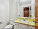 Bathroom featuring a mirror, sink, and toilet with gold colored fixtures at 5527 Vin Rose Ln, Lawrence, IN 46226