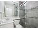 Bathroom featuring glass enclosed shower with stone floor and tile walls, sink and toilet at 5527 Vin Rose Ln, Lawrence, IN 46226