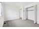 Sunlit bedroom with neutral walls, carpet flooring, and spacious closet at 5527 Vin Rose Ln, Lawrence, IN 46226