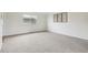 Bright bedroom with neutral carpeting, white walls, and a large window at 5527 Vin Rose Ln, Lawrence, IN 46226