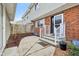Charming brick townhome entrance with concrete steps, white railings, and a welcoming flower pot at 5527 Vin Rose Ln, Lawrence, IN 46226