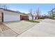 Multiple two car garages with long concrete driveways on a sunny day at 5527 Vin Rose Ln, Lawrence, IN 46226
