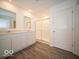 Bathroom featuring double sinks, a vanity with white cabinets, and a glass shower at 6623 Sulgrove Pl, Indianapolis, IN 46221
