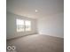 Bright bedroom featuring a large window and neutral carpet at 6623 Sulgrove Pl, Indianapolis, IN 46221