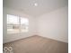 Bright, carpeted bedroom with a large window offering natural light at 6623 Sulgrove Pl, Indianapolis, IN 46221