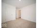 Cozy bedroom features plush carpeting and bright white doors at 6623 Sulgrove Pl, Indianapolis, IN 46221