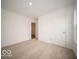 Bright bedroom featuring neutral carpet, white walls, and a view of the closet at 6623 Sulgrove Pl, Indianapolis, IN 46221