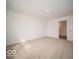 Spacious bedroom with neutral carpet and an open door to a walk-in closet at 6623 Sulgrove Pl, Indianapolis, IN 46221