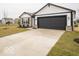 Charming single-story home showcasing a two-car garage and well-maintained front lawn at 6623 Sulgrove Pl, Indianapolis, IN 46221