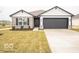 Charming single-story home featuring a gray two-car garage, stone accents, and manicured front lawn at 6623 Sulgrove Pl, Indianapolis, IN 46221