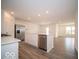 Open-concept kitchen with island, stainless appliances, and hard surface floors at 6623 Sulgrove Pl, Indianapolis, IN 46221