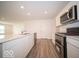 Modern kitchen featuring stainless steel appliances, white cabinets, and a spacious island with a sink at 6623 Sulgrove Pl, Indianapolis, IN 46221