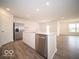 Open-concept kitchen with stainless steel appliances, white cabinets, and center island with sink at 6623 Sulgrove Pl, Indianapolis, IN 46221