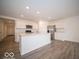 Modern kitchen featuring white cabinetry and a large center island at 6623 Sulgrove Pl, Indianapolis, IN 46221